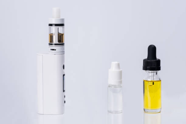 istock electronic cigarette and liquid for its refueling on a white background 946503122
