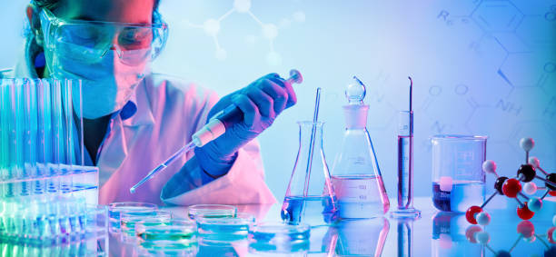 chemistry laboratory - woman with pipettes and test tubes - test tube laboratory chemical science imagens e fotografias de stock