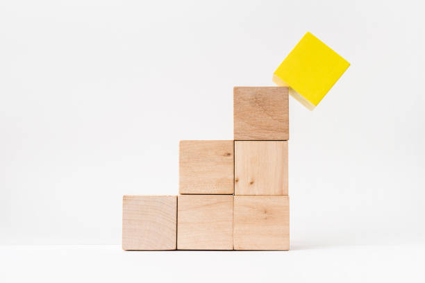 istock abstract geometric real wooden cube pyramid on white floor background 946509576