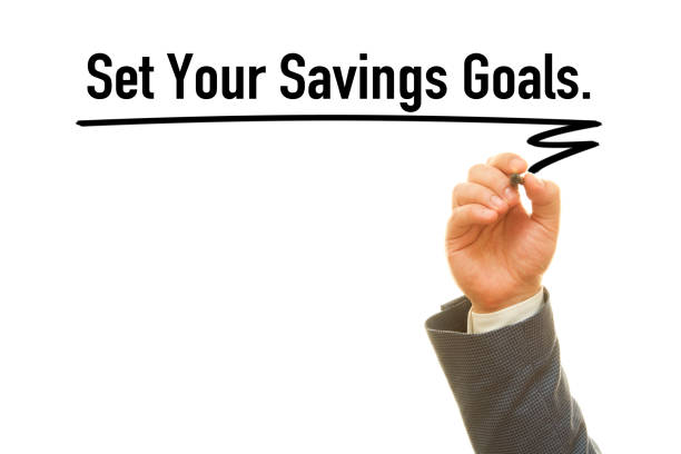 Set your savings goals Man hand writing ‘Set your savings goals’ message on wipe background the human body writing black human hand stock pictures, royalty-free photos & images