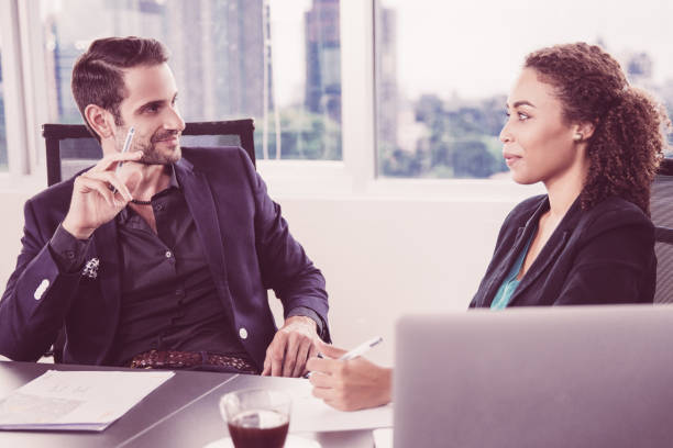 istock Businessman Looking at Colleague 946510212