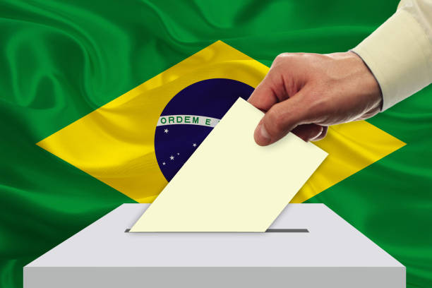 istock Man voting on elections in BRAZIL front of flag 946516064