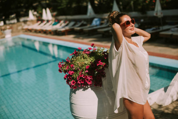 istock Young woman standing next to the swimming pool 946521188