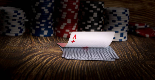 istock ace-card and poker chips, on a wooden background 946524980