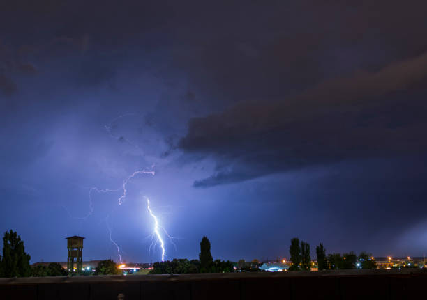 istock Lightning flash over a city, Thunderstorm , electricity blast storm 946525538