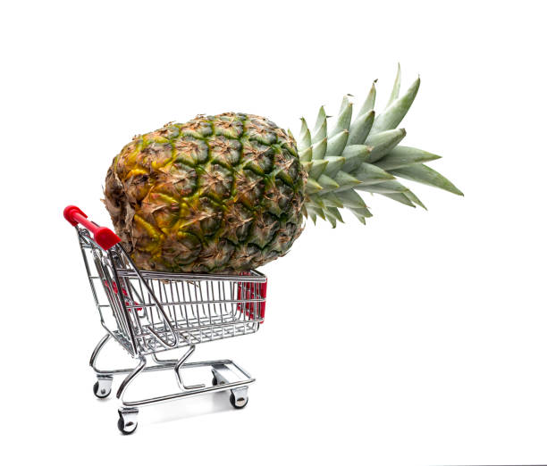 istock Shopping cart with pineapple isolated on white background 946525940