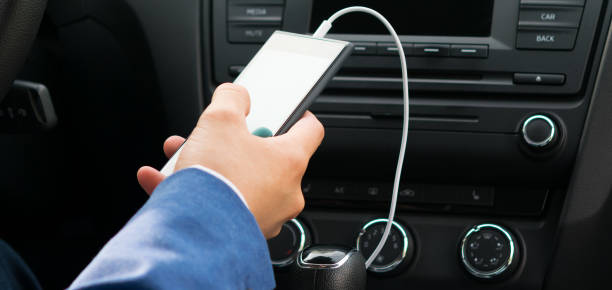 istock car panel and white charger for phone in hand 946531384