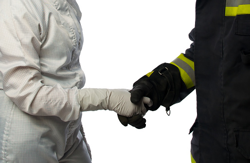 handshake of a scientist in a white protective suit and a fireman, on white
