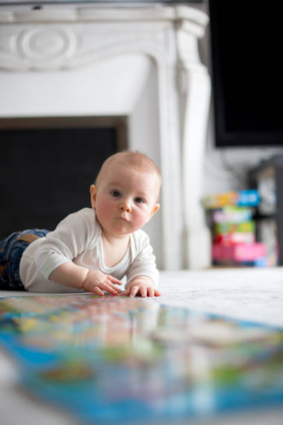 istock Cute little baby boy, playing at home, crawling 946535890