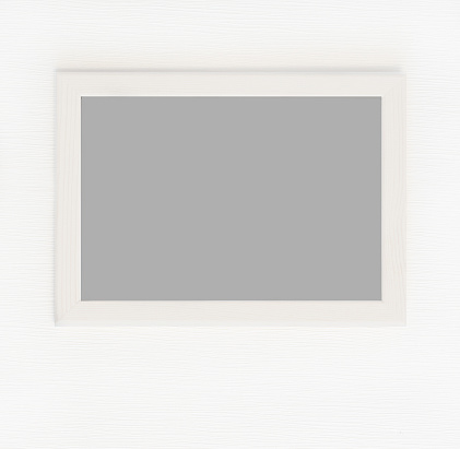 Light wooden frame for picture isolated on white wall