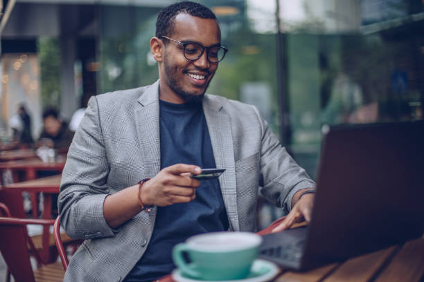istock Man sitting in coffee shop and using laptop 946539018