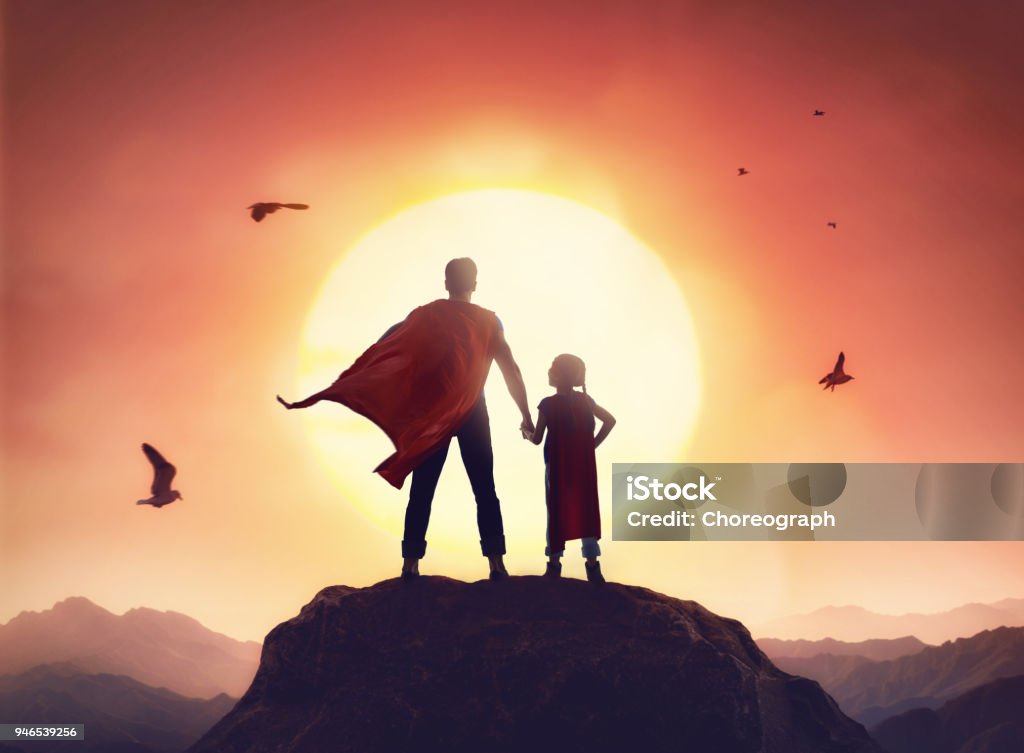 Father and daughter playing outdoors Happy loving family. Father and his daughter playing outdoors. Daddy and his child girl in an Superhero's costumes. Father Stock Photo