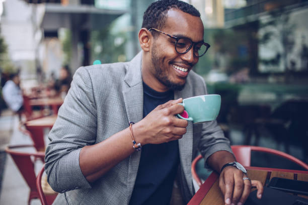 istock Handsome man sitting in coffee shop and using laptop 946539564