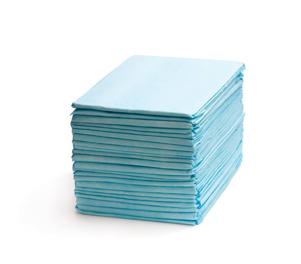 Stack  of disposable bed pads isolated on white Stack  of disposable bed pads isolated on white protective sportswear stock pictures, royalty-free photos & images