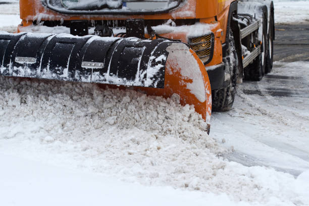front view of snow plug on city street front view of an orange snow plug working on a city street moving van stock pictures, royalty-free photos & images