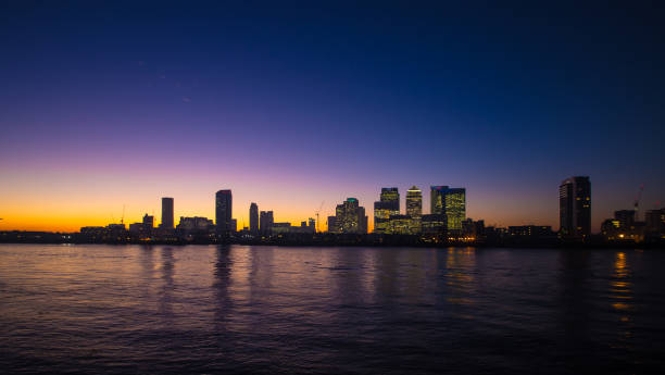 London England Panoramic view of London Docklands  at night Canary Wharf England clear sky night sunset riverbank stock pictures, royalty-free photos & images