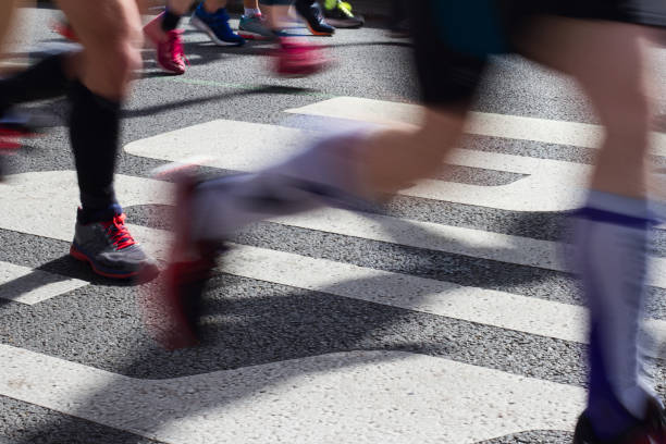 istock closeup on marathon runners legs and feet with motion blur 946549452