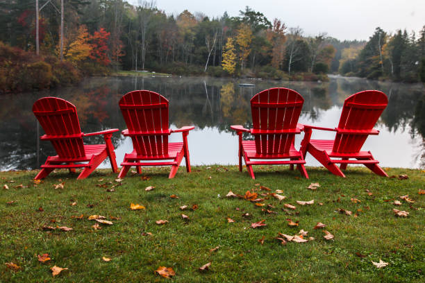istock Four red chairs with autumn colors 946552058