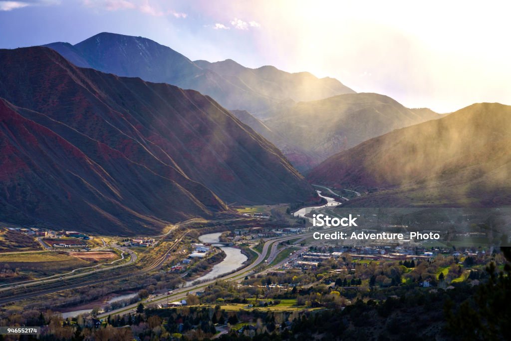 Glenwood Springs Stormy Landscape View Glenwood Springs Stormy Landscape View - Mountains and valley with dramatic sunset light and misty clouds. Colorado Stock Photo