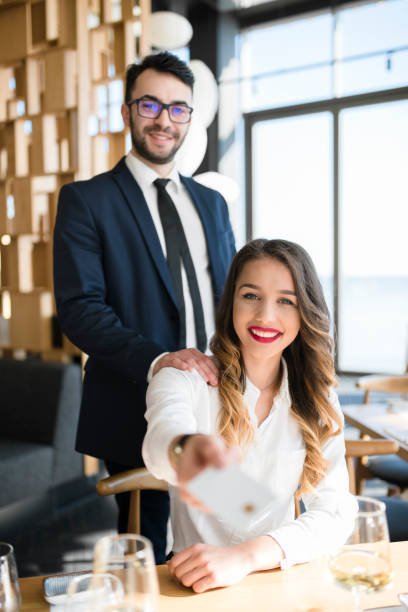 istock Business couple about to pay using credit card 946552688