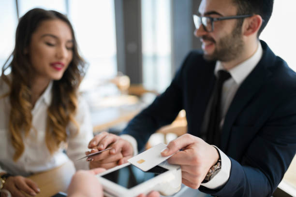 istock Business people completing transaction with credit card 946552916