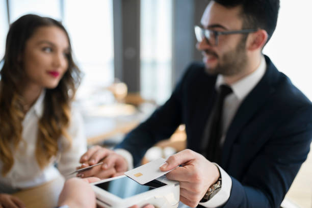 istock Eastern European team mates using credit card to pay bill 946552946