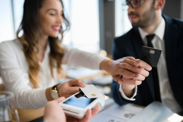 istock Eastern European colleagues making contactless payment 946553044