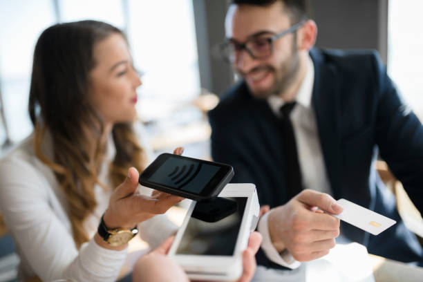 istock Office lady using smart phone to pay for meal 946553316