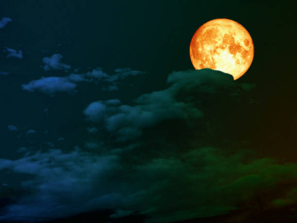 istock super full blood moon back dark green heap cloud 946559588