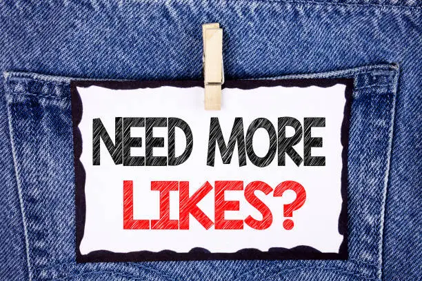 Photo of Text sign showing Need More Likes Question. Conceptual photo Social media create more fans followers community written on White Sticky Note Paper hanging with Clip on the Jeans background.