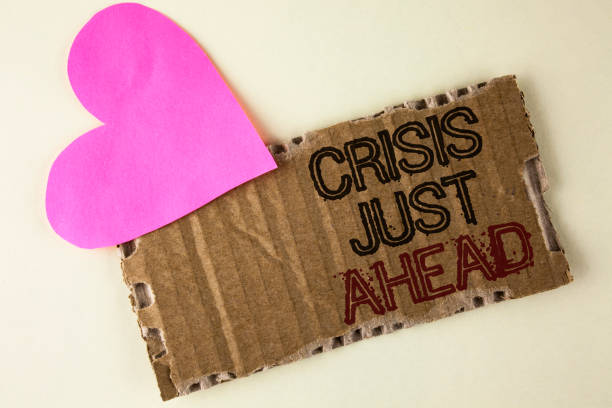 istock Handwriting text Crisis Just Ahead. Concept meaning Foresee failure take right action before it is late written on Tear Cardboard Piece on the plain background Heart next to it. 946560720