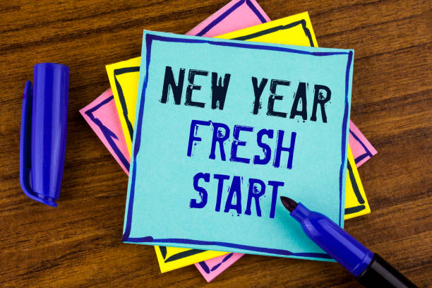 istock Handwriting text writing New Year Fresh Start. Concept meaning Time to follow resolutions reach out dream job written on Sticky note paper on wooden background Marker next to it. 946563428