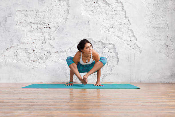istock Beautiful young woman doing yoga 946563646