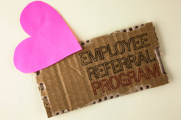 istock Handwriting text Employee Referral Program. Concept meaning Recommend right jobseeker share vacant job post written on Tear Cardboard Piece on the plain background Heart next to it. 946566606