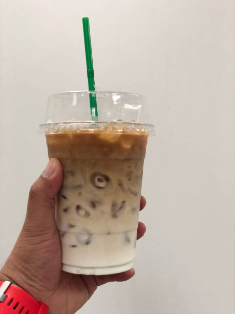Iced coffee hold by man hand ready to drink