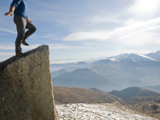 istock Climber ascends to mountain summit, mountains below, Piedmont, Italy 946573620