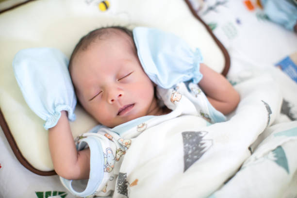 istock Baby boy sleeping on the bed. growth hormone and sleep in infant. 946573912