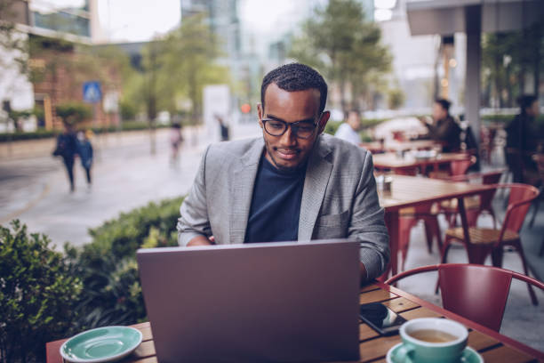 Young man sitting in coffee shop and using laptop