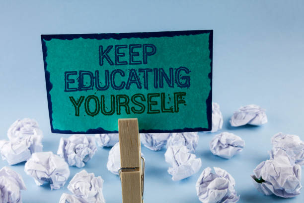 istock Text sign showing Keep Education Yourself. Conceptual photo Learning skills with your own competencies written on Sticky Note Paper holding by Clip on plain background White Paper Balls 946574190