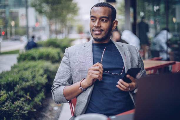 istock Man sitting in coffee shop and using phone 946574320
