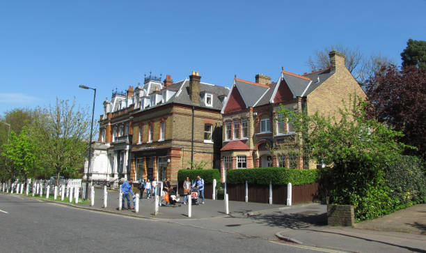 London, UK - 5th April 2014: People with children walking in south London street