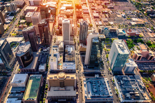 Downtown Phoenix Aerial View An aerial view of downtown Phoenix, Arizona and the surrounding urban area shot from a helicopter nearing dusk. urban sprawl stock pictures, royalty-free photos & images