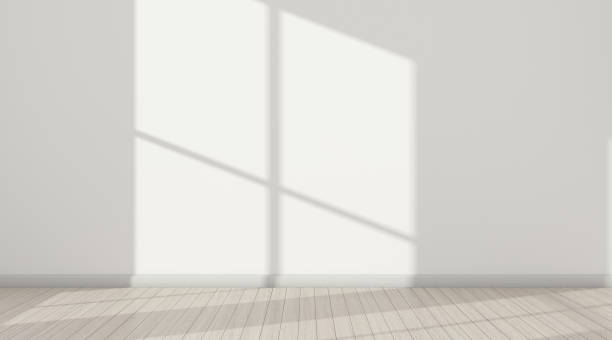 istock 3D stimulate of white room interior and wood plank floor with sun light cast  the window shadow on the wall,Perspective of minimal design architecture 946596670