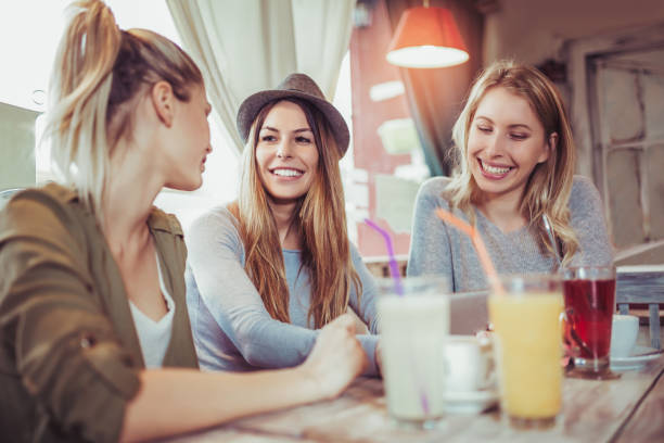istock Group of female friends in cafe using digital tablet 946597912