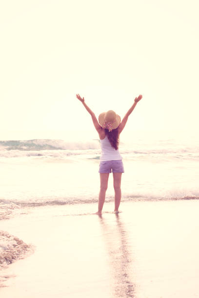 istock Clear your mind on beach at sunset. Freedom Concept. 946600020