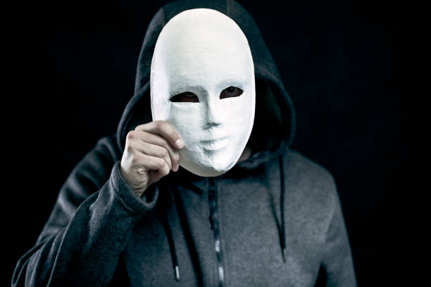 istock Man holding white mask for hide his face 946610502