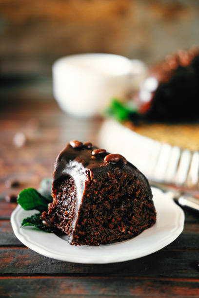 istock Sweet chocolate cake with cacao icing and decorated with mint and chocolate drops 946610638