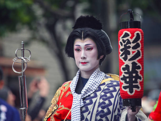 Oiran Festival at Asakusa Kannon-ura Street (Oiran Douchu) Tokyo, Japan - April 14, 2018: Participant wearing kimono in white make-up holding a lantern performs in the parade of Edo Yoshiwara Oiran-dochu Procession (江戸吉原おいらん道中) on the street at the 16th Asakusa Kannon-ura Ichiyo Sakura Matsuri Festival (浅草観音うら一葉桜まつり). This street festival is held at Komatsubashi Dori Street in the northern district of Asakusa, situated at the back of Sensoji Temple. oiran stock pictures, royalty-free photos & images