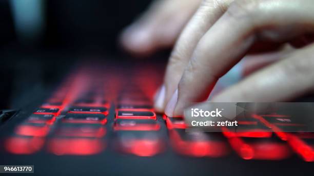 Teenage Hacker Girl Attacks Corporate Servers In Dark Typing On Red Lit Laptop Keyboard Room Is Dark Stock Photo - Download Image Now