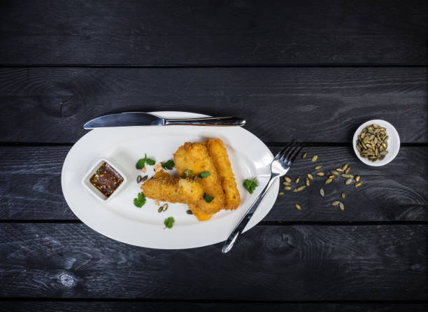 istock Cheese sticks served on white plate with sauce. 946614068